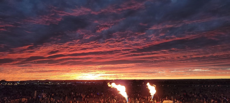 A vibrant sunset over a local event.