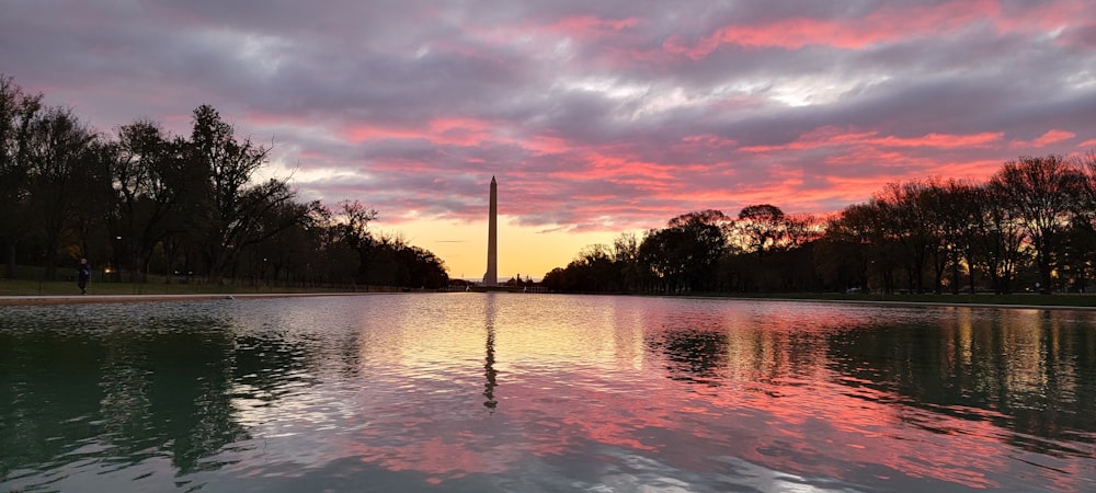 a body of water with a monument in the background