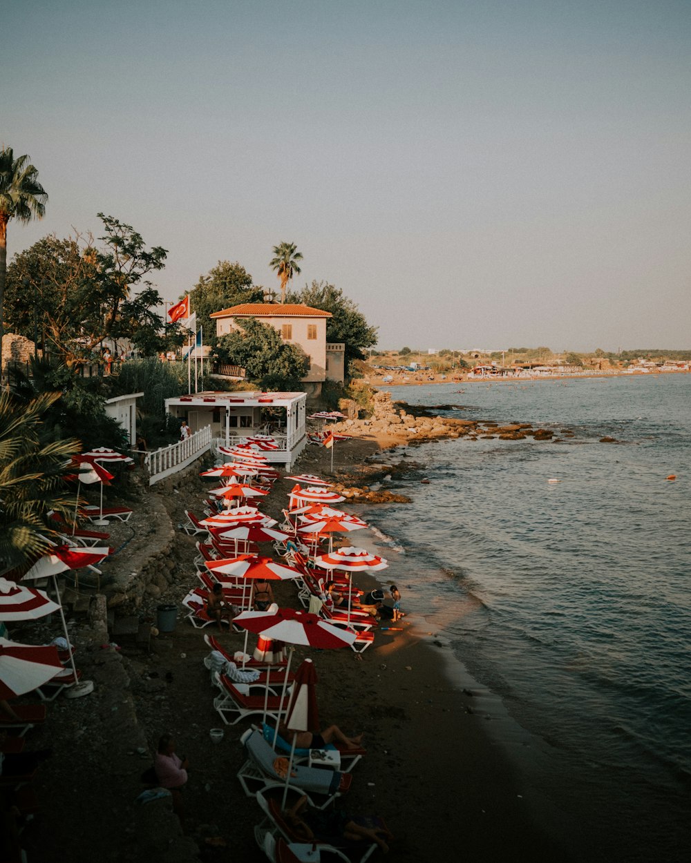 a beach with many umbrellas and chairs on it