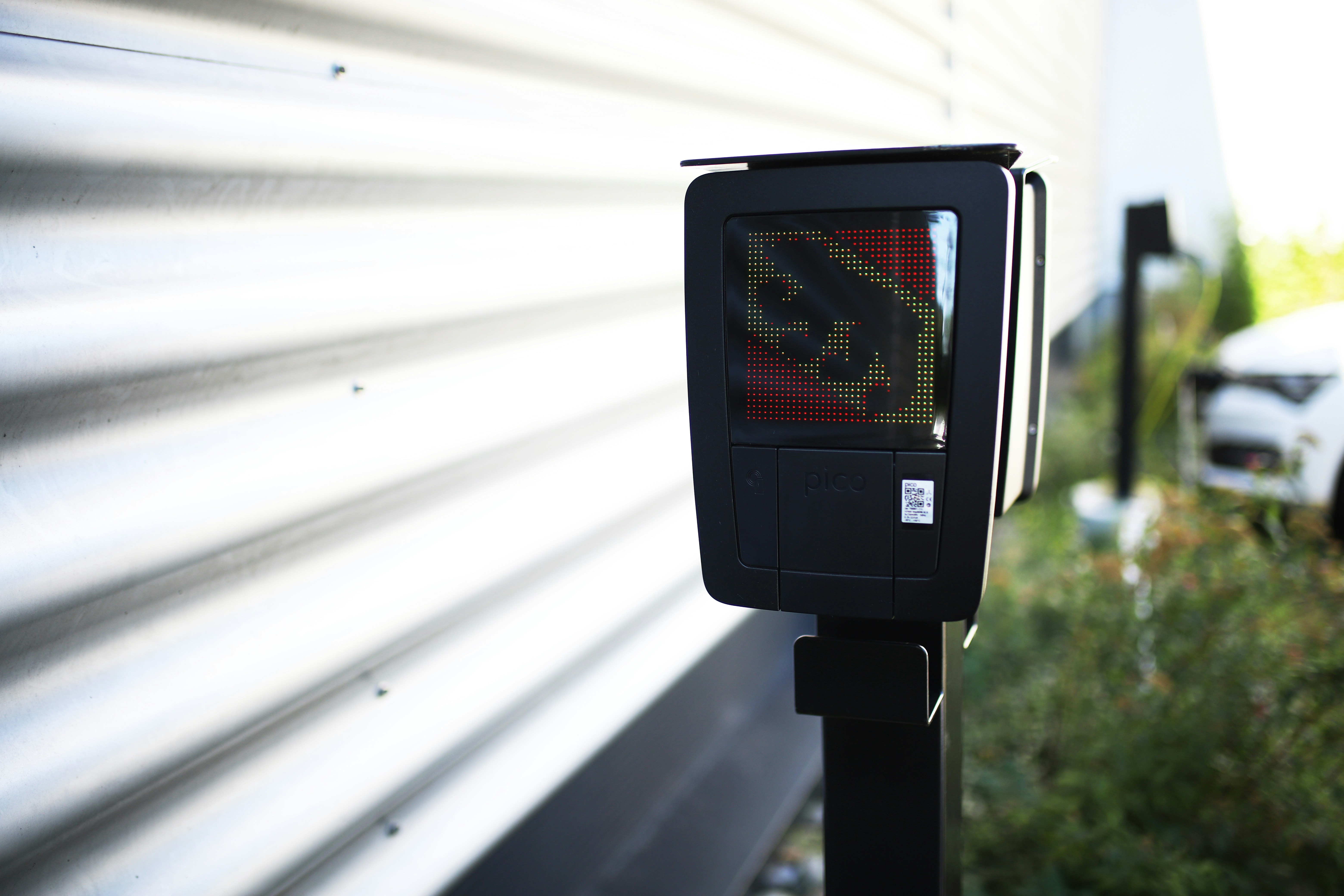Electric vehicle charging station display showing a green light.