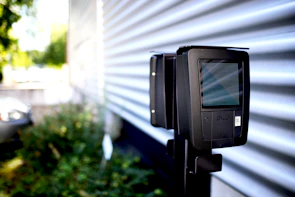Close-up of a sleek Spy Game Gear electronic gadget glowing with neon accents on a graffiti-covered wall.