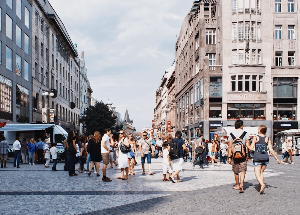 a group of people walking in a city