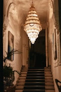 a staircase with a chandelier