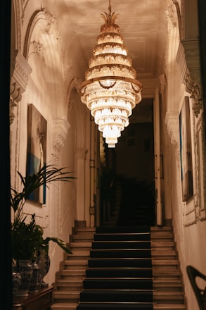 a staircase with a chandelier