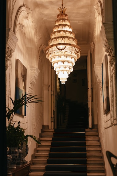 a staircase with a chandelier