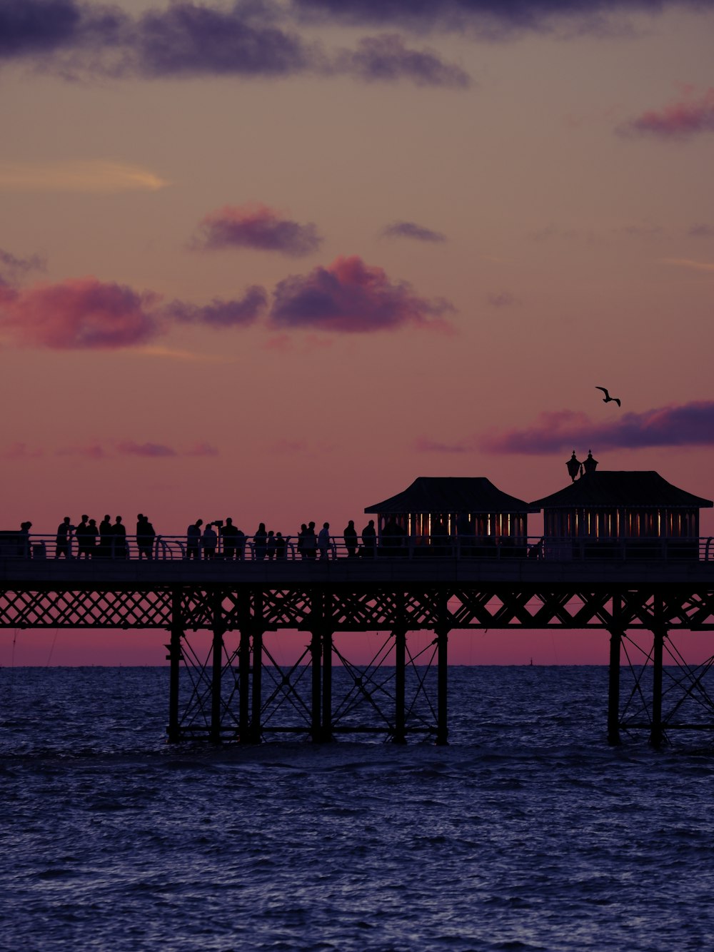 a pier with a group of people on it