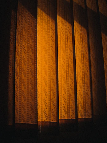 Custom curtains in warm tones framing a large window, enhancing the room’s inviting atmosphere.