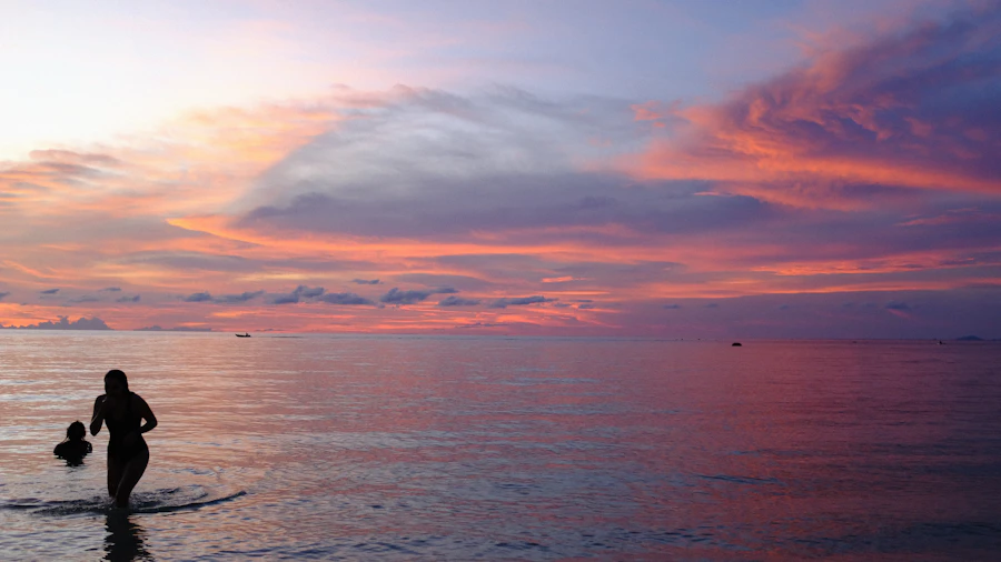 People wading in the shallow turquoise water off a Koh Phangan beach