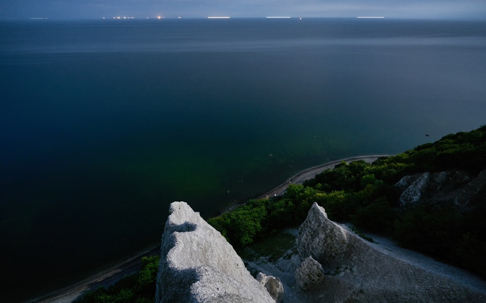 a rocky cliff overlooking a body of water