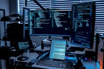 a desk with several monitors