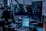 a desk with several monitors