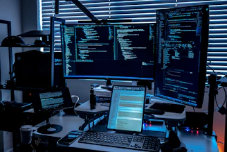 a desk with several monitors