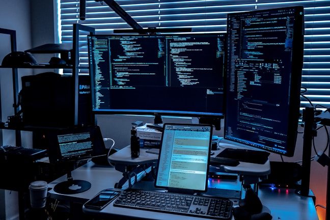 a desk with several monitors