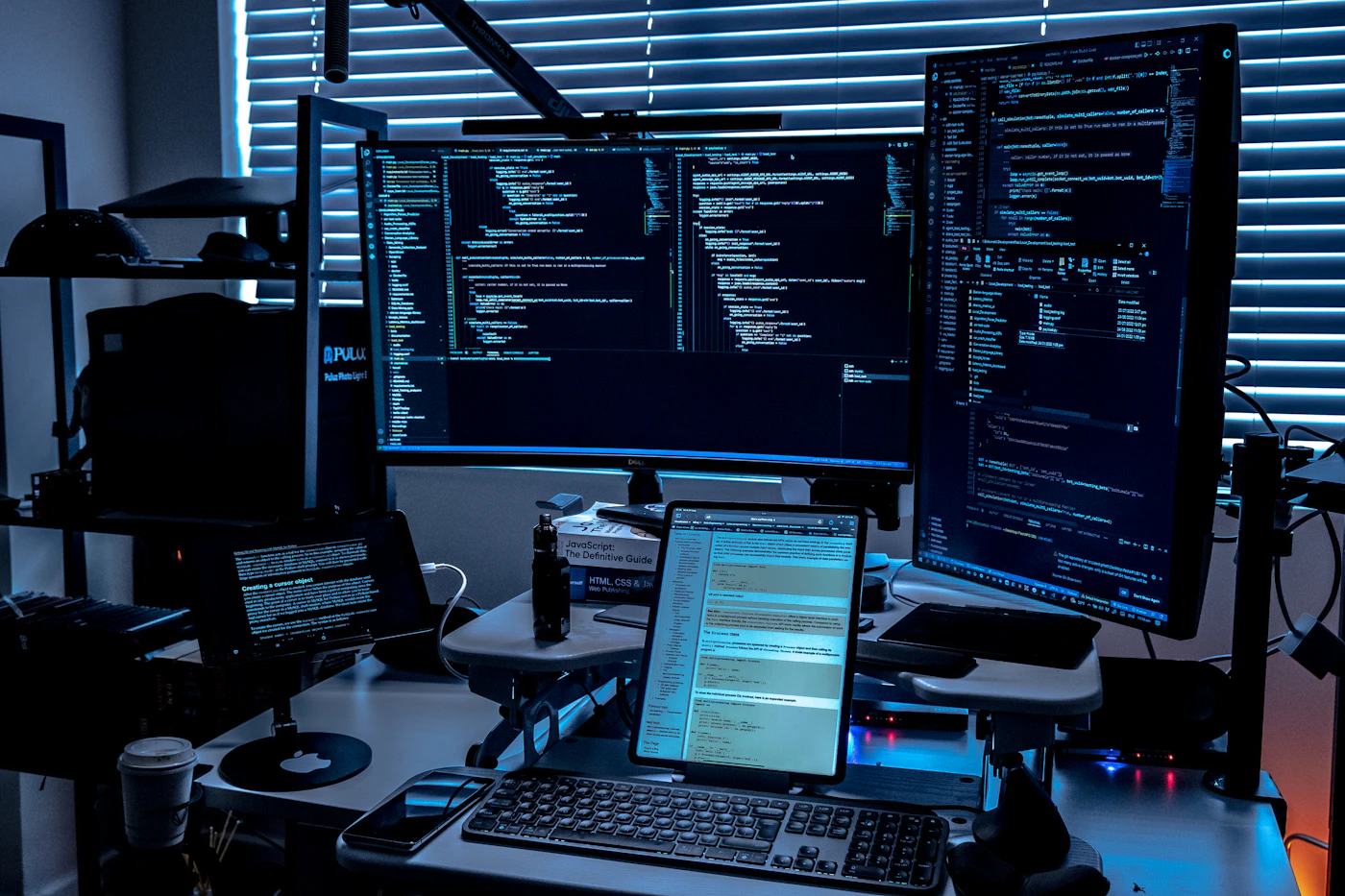 Real-photo placeholder of a multi-monitor desk setup for a trading and research environment.