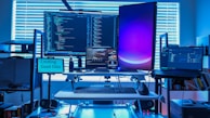 a desk with several computers