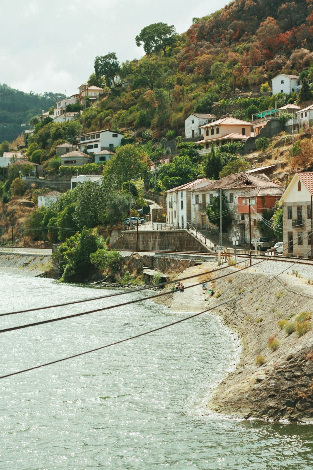 a river with a bridge and buildings along it