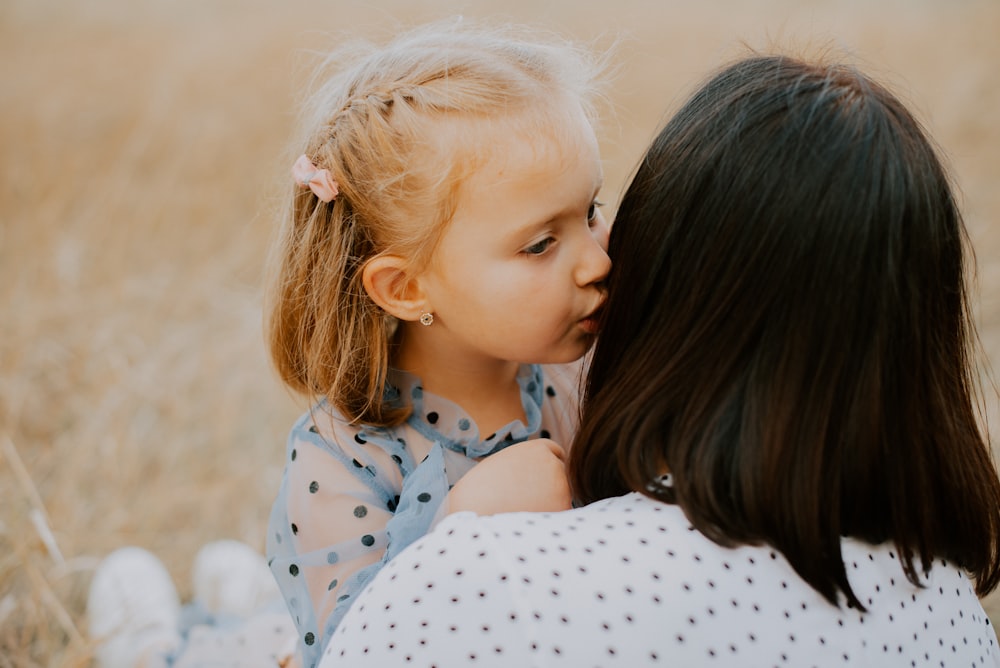 a person kissing a baby