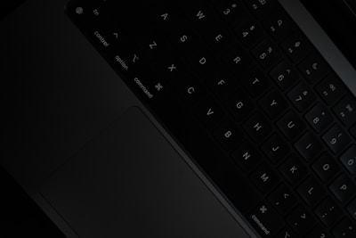 a black keyboard with white keys