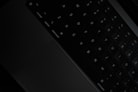 a black keyboard with white keys
