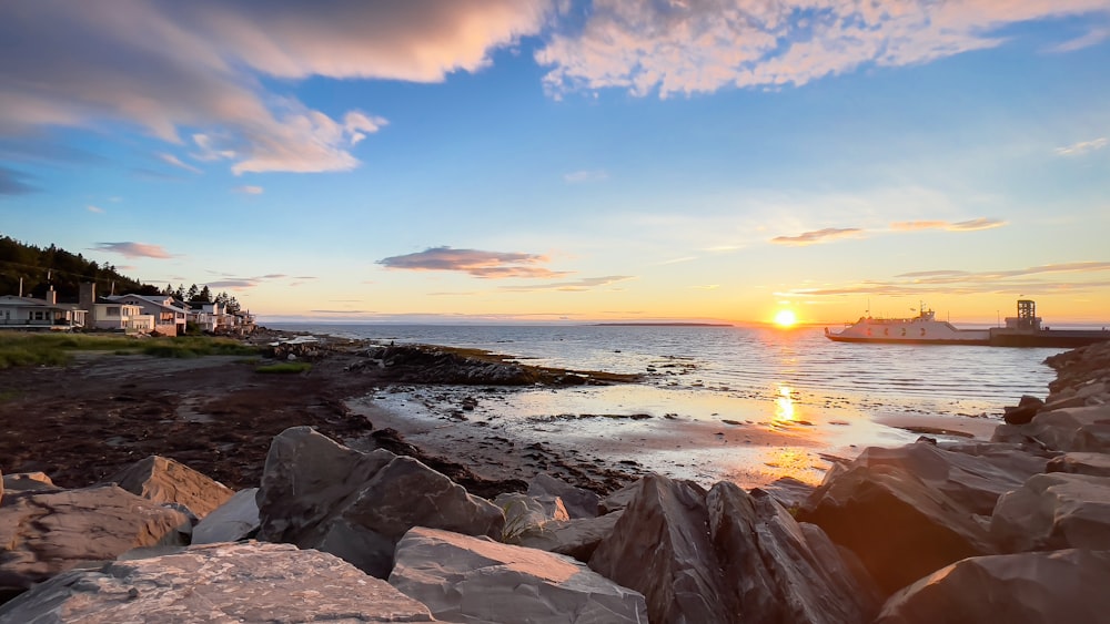 a rocky beach with a sunset