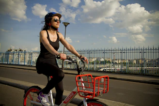 A happy rider unlocking a bike through the Veloza app on a sunny city street.