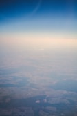 Aerial view of a vast green farm with clear blue sky.