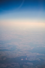 Aerial view of lush green farmland near Bhiwani under clear blue sky.