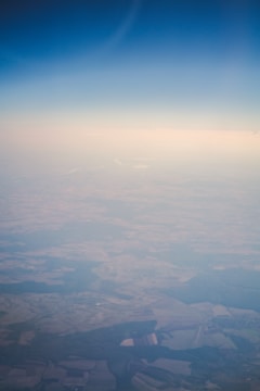 Aerial view of a rural farmland with clear boundary lines under a bright sky.