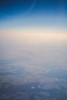Aerial view of a vast rural land with clear boundaries and green pastures under a bright sky.