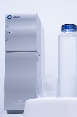 a white machine with a blue cap