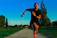 Athlete running on a trail during sunrise, showing determination and focus.