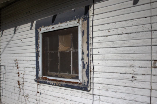 Before and after image showing restored wooden window frames with fresh paint and repaired wood.