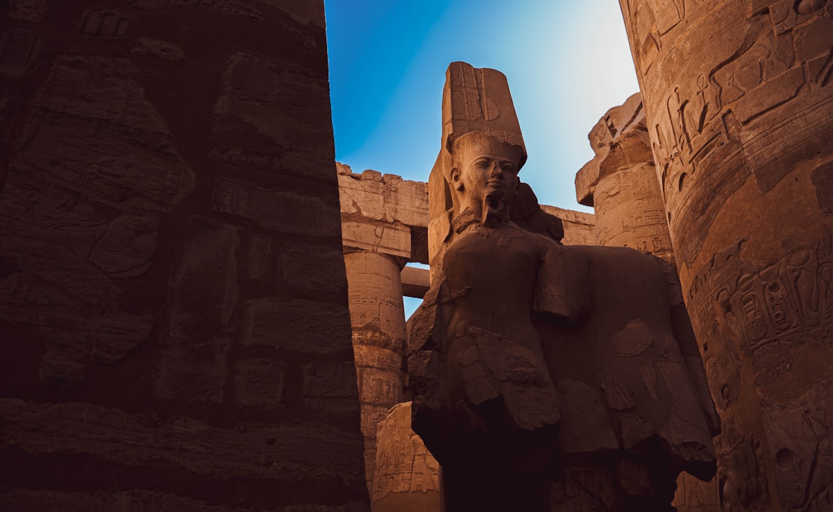 Luxor Temple at night illuminated with Corniche promenade in foreground