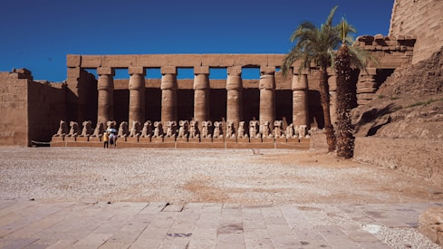a group of people standing in front of a building with columns