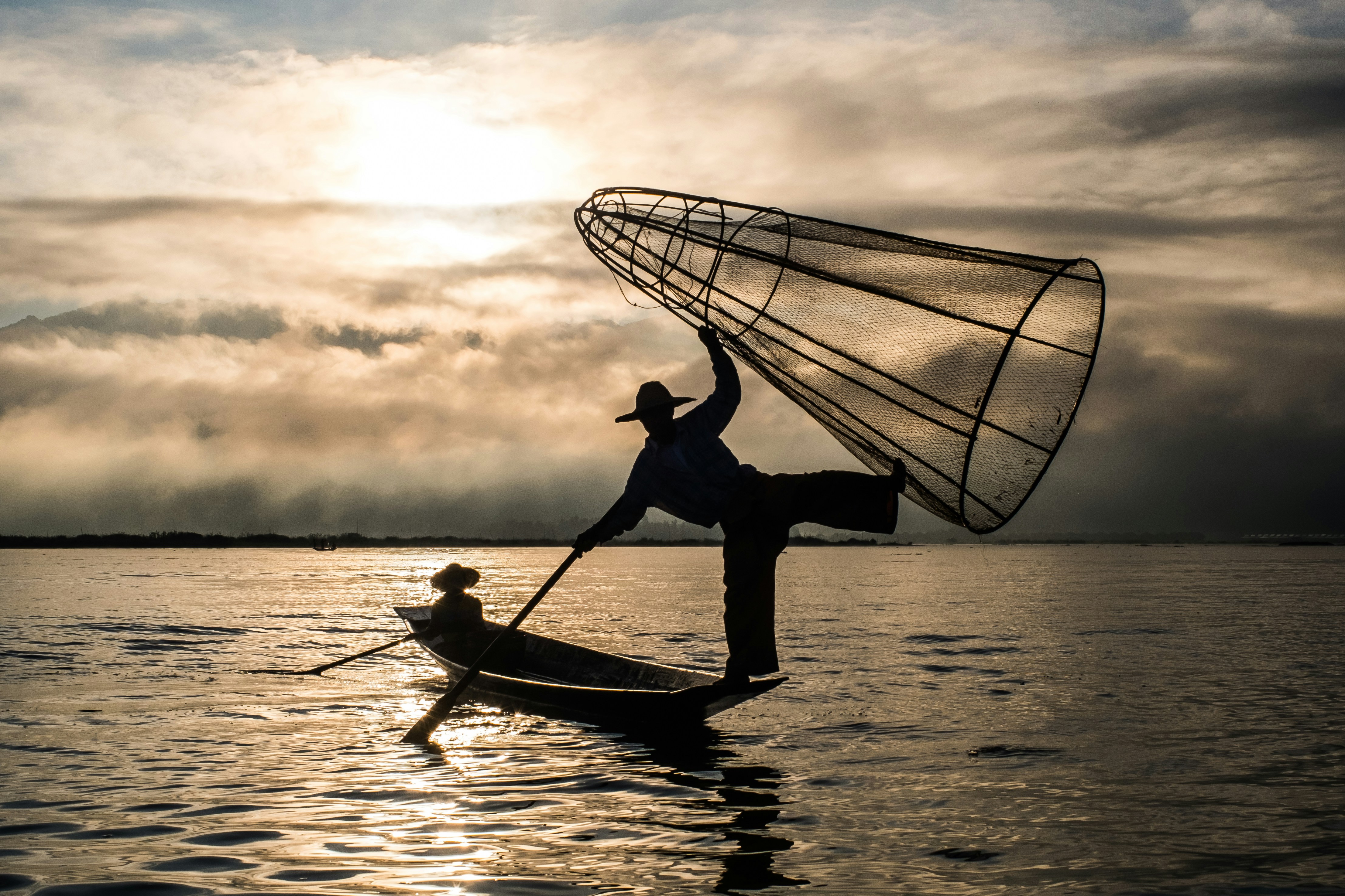 a man and a woman paddling a canoe on water