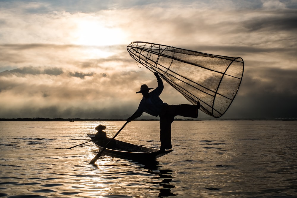 a man and a woman paddling a canoe on water