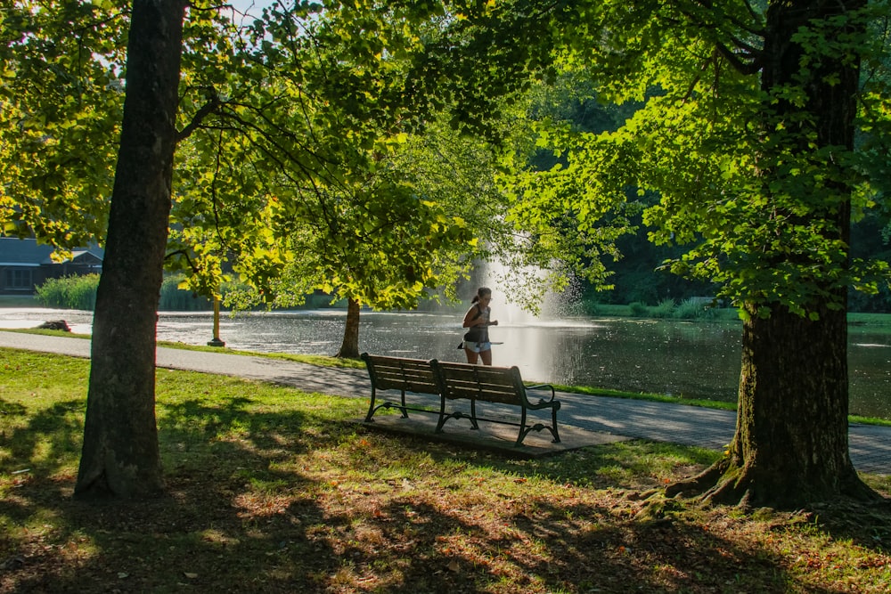 a person sitting on a bench in a park