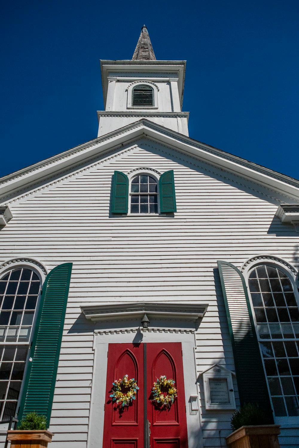 a white building with green shutters