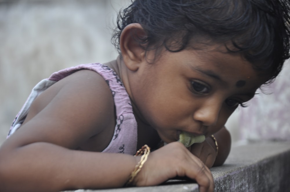 a young girl holding a lizard