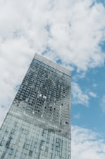 a tall building with a cloudy sky