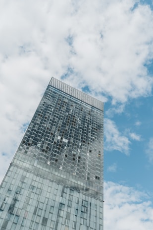 a tall building with a cloudy sky
