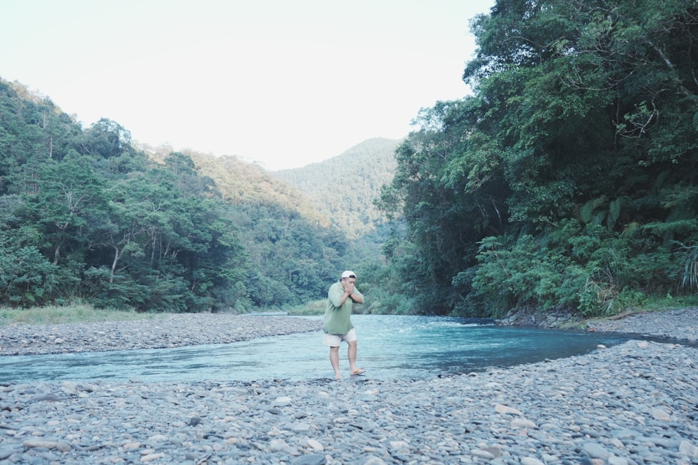 a man standing on a rocky shore