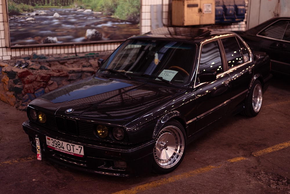 a black car parked in a parking lot