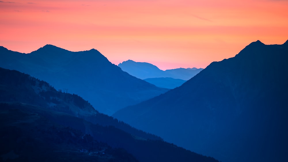 a valley with mountains in the background