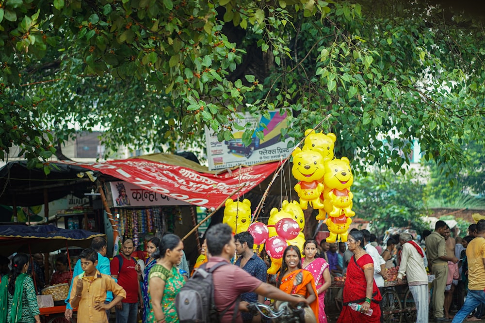 a crowd of people at an outdoor market