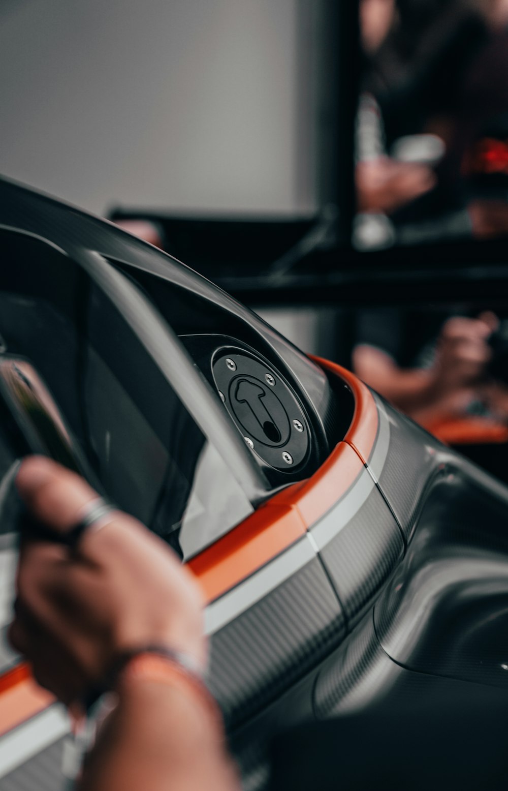 a person holding a car steering wheel