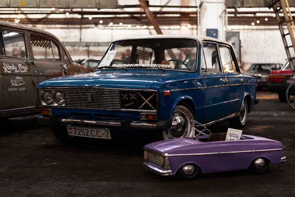 a blue car parked next to a purple car