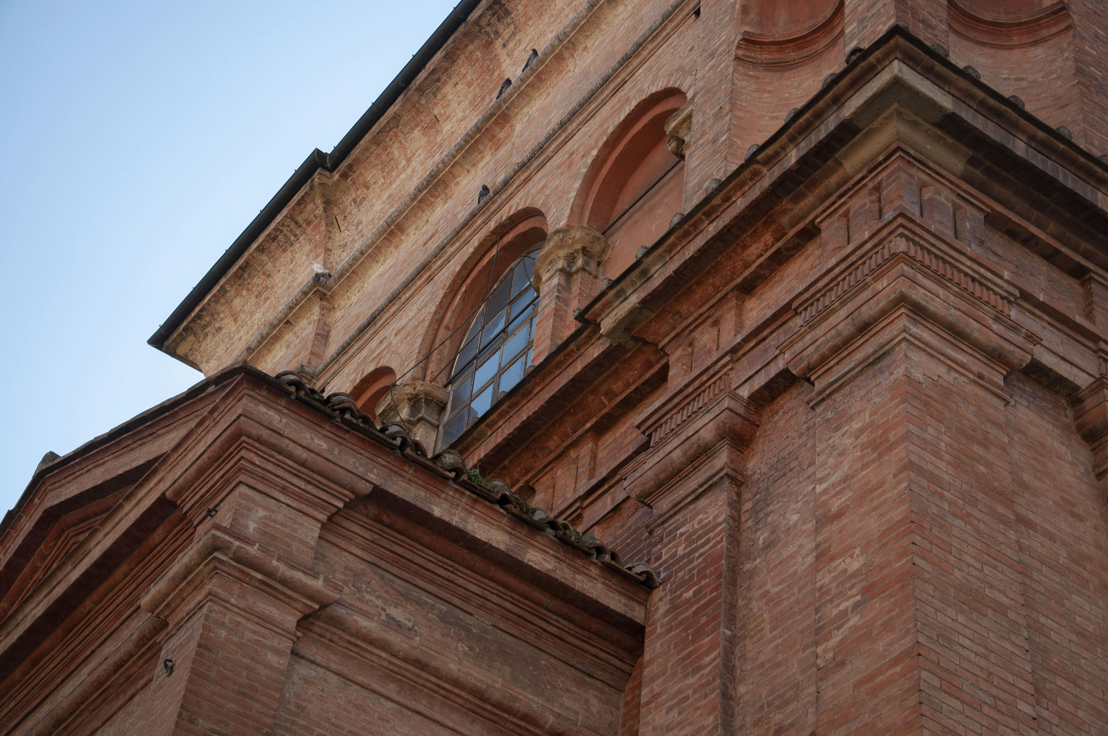 a brick building with a statue on the side