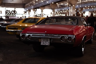 a red car parked next to a yellow car
