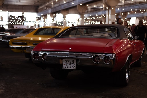 a red car parked next to a yellow car